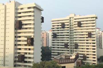 a couple of tall buildings sitting next to each other